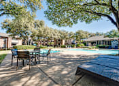 Thumbnail 32 of 72 - pool surrounded by trees at Southern Oaks, Fort Worth, TX