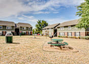 Thumbnail 5 of 17 - Courtyard area with picnic tables and green space at Arbors Of Cleburne Apartments, Cleburne, Texas