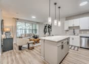 Thumbnail 5 of 53 - Open concept kitchen and living room with island at The Barton Apartments, Dallas, Texas