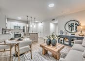 Thumbnail 7 of 53 - Open living area with dining table and modern furnishings at The Barton Apartments, Dallas, 75206