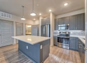 Thumbnail 3 of 29 - A modern kitchen with a large island in the middle.