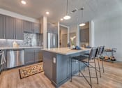Thumbnail 2 of 29 - A kitchen with a large island and modern appliances.