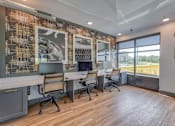 Thumbnail 17 of 29 - A modern office space with a long table and chairs, a patterned wall, and a view of the outdoors.