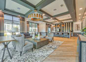 Thumbnail 24 of 29 - A modern living room with a grey sofa and a wooden coffee table.