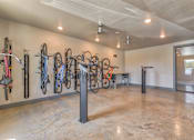 Thumbnail 14 of 29 - A room with a wall of bicycles and a bench.
