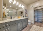 Thumbnail 6 of 29 - A bathroom with a sink, mirror, and toilet.
