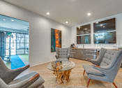 Thumbnail 20 of 37 - Contemporary lounge with wet bar and seating at Vue Live Oak Apartments, Dallas