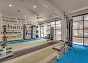 Thumbnail 29 of 37 - Fitness center with cable machines and equipment at Vue Live Oak Apartments, Dallas, TX 75204