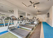 Thumbnail 28 of 37 - Fitness center with cardio equipment at Vue Live Oak Apartments, Dallas, TX