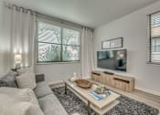 Thumbnail 6 of 37 - Living room with tv and entertainment center at Vue Live Oak Apartments, Dallas, TX 75204