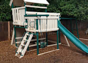 Thumbnail 3 of 13 - A wooden playset with a green slide in the backyard.