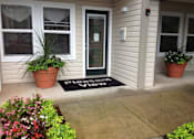 Thumbnail 6 of 13 - A house entrance with a doormat that says "Please knock".