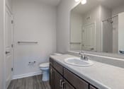 Thumbnail 8 of 19 - A bathroom with a toilet, sink, and mirror.