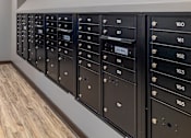 Thumbnail 16 of 19 - A row of black mailboxes with numbers 156 to 165.