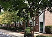 Thumbnail 1 of 9 - A tree in front of a building with the number 333 on it.