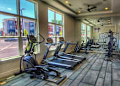 Thumbnail 1 of 17 - A gym with treadmills and exercise bikes.