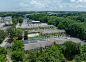 Thumbnail 22 of 22 - A large building complex surrounded by trees.