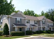 Thumbnail 6 of 6 - A large, two-story house with a grey and white exterior and a brown roof.
