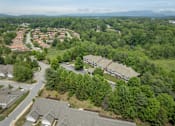 Thumbnail 24 of 25 - A bird's eye view of a residential area with houses and trees.