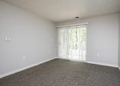 Thumbnail 13 of 25 - A room with a carpeted floor and a window with blinds.