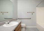 Thumbnail 8 of 25 - A bathroom with a sink, toilet, and bathtub.