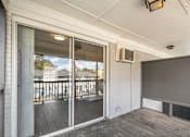 Thumbnail 23 of 23 - A room with a sliding glass door leading to a balcony.