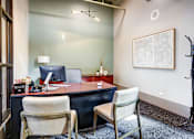 Thumbnail 8 of 41 - a desk with two chairs in the Ovaltine Court leasing center