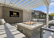Thumbnail 16 of 40 - A patio with a fire pit and a sign that says Marquette.