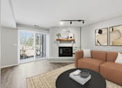 Thumbnail 8 of 24 - A living room with a fireplace and sliding glass doors.