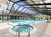 Thumbnail 1 of 40 - A large indoor pool with a glass ceiling.