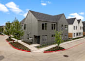 Thumbnail 33 of 46 - A modern building with a grey facade and a red curb in front.