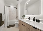Thumbnail 23 of 46 - A modern bathroom with a marble patterned shower and a white toilet.