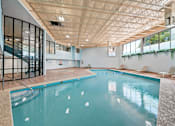 Thumbnail 15 of 20 - A large indoor swimming pool with a glass wall on one side.