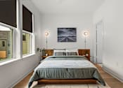Thumbnail 12 of 46 - A bedroom with a large bed and a painting on the wall.