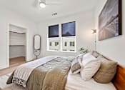 Thumbnail 17 of 46 - A bedroom with a large bed and a painting on the wall.