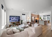 Thumbnail 9 of 46 - A modern living room with a large couch and a television.