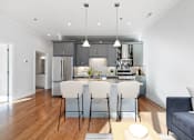 Thumbnail 6 of 32 - A modern kitchen with a dining table set for two.