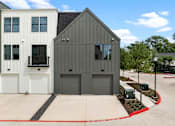 Thumbnail 46 of 46 - A modern two-story building with a garage door and a white garage door.