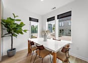 Thumbnail 5 of 46 - A dining room with a white table and chairs.