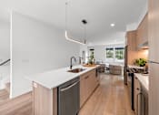 Thumbnail 4 of 46 - A modern kitchen with wooden cabinets and stainless steel appliances.