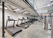 Thumbnail 11 of 20 - A gym with treadmills and other exercise equipment.