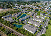 Thumbnail 34 of 37 - an aerial view of a city with houses and a pool