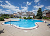 Thumbnail 13 of 47 - a large swimming pool with houses in the background