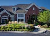 Thumbnail 43 of 47 - a large house with a driveway and landscaping in front of it
