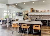 Thumbnail 4 of 47 - a kitchen with a center island and chairs in front of a table