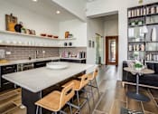 Thumbnail 5 of 47 - a kitchen with a large island and a table with chairs