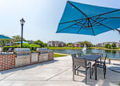 Thumbnail 16 of 47 - our patio with a table and chairs and an umbrella