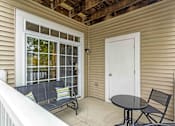 Thumbnail 41 of 47 - a small porch with a table and chairs and a door