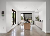 Thumbnail 40 of 46 - A modern office with a reception desk and a view of the outside.