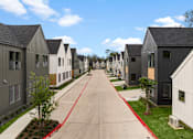 Thumbnail 36 of 46 - A long row of houses with a red line down the middle of the road.